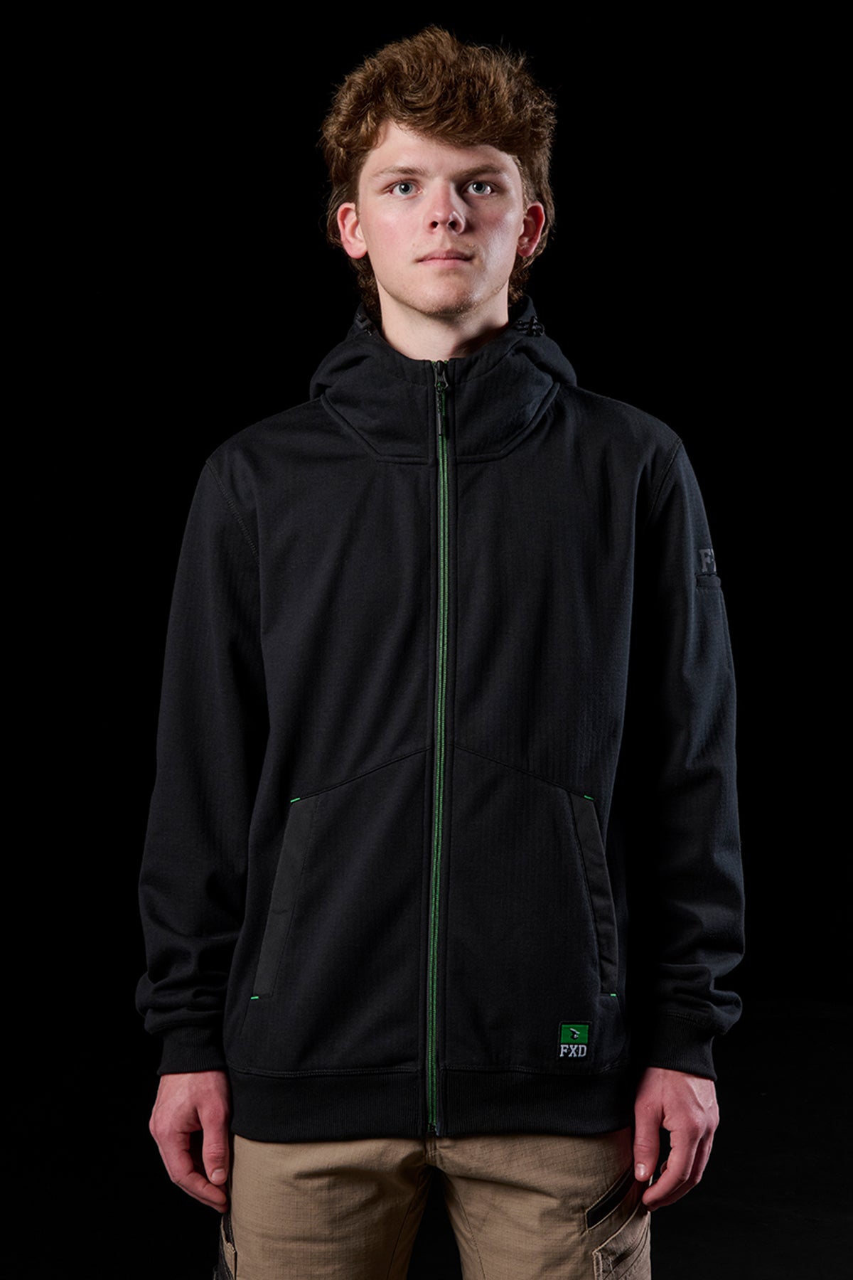 Front view of a person wearing a black WF-3 bonded fleece hoodie with green zipper and hood