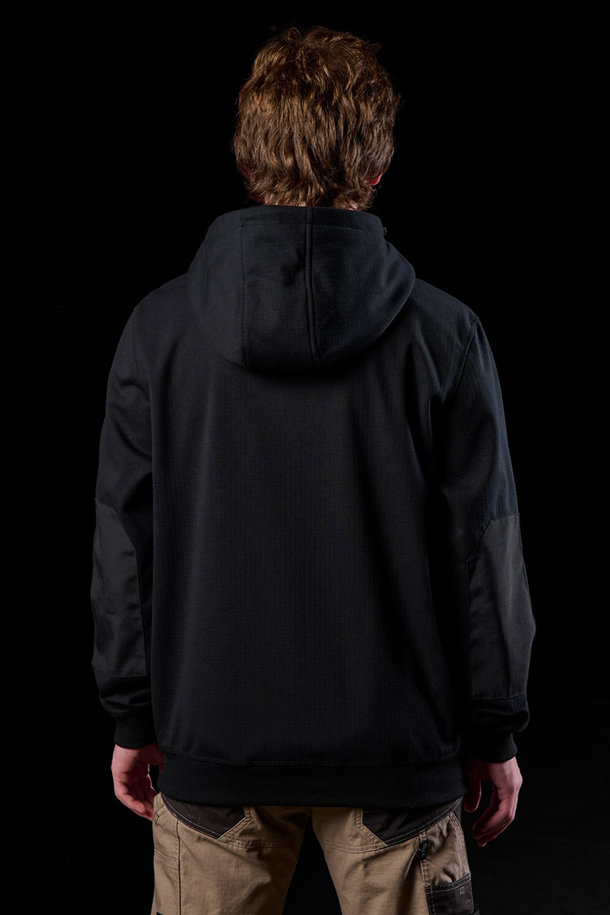 Back view of a person wearing a black WF-3 bonded 3-layer fleece zip hoodie with the hood down.