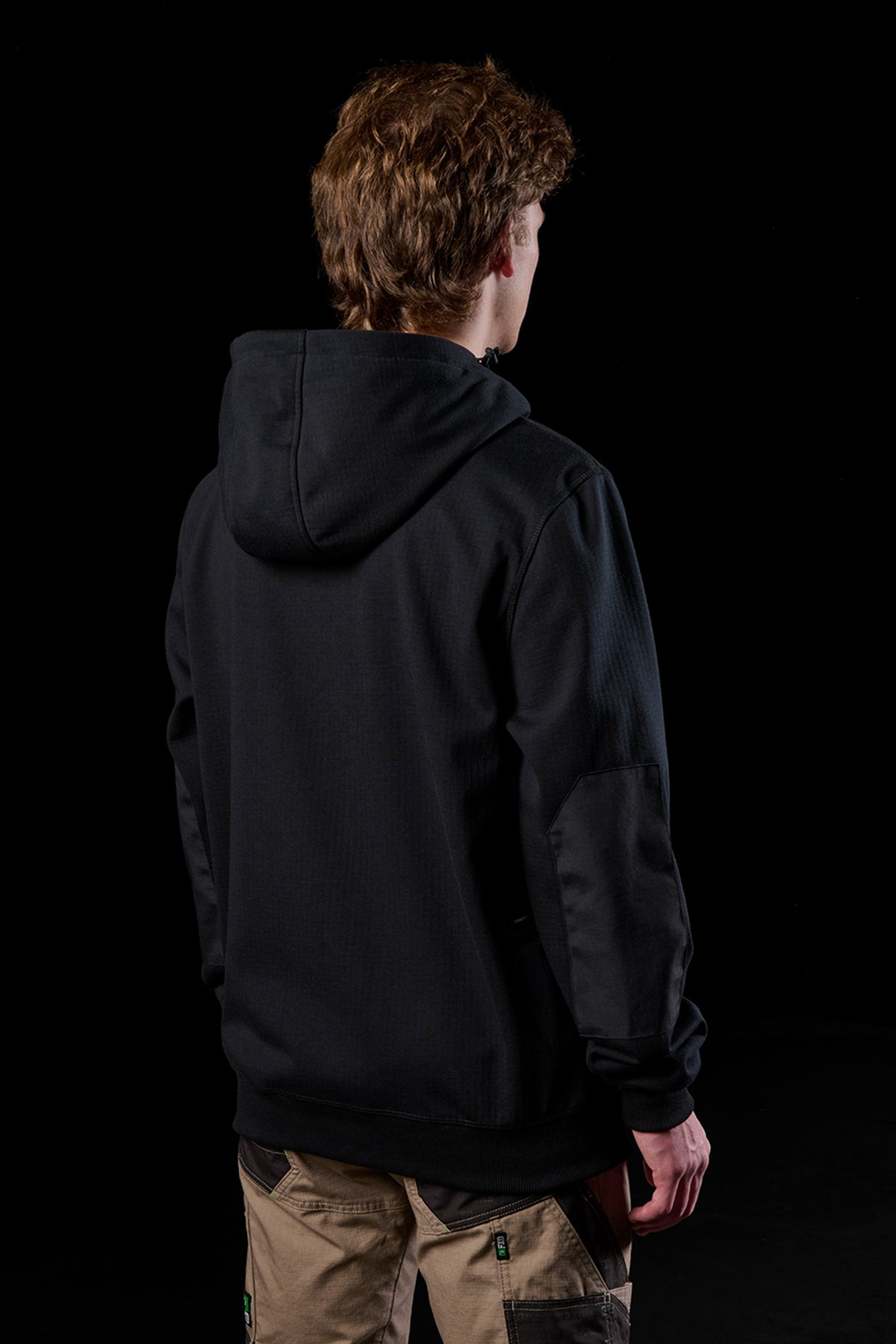 Back view of person wearing black WF-3 bonded fleece hoodie with hood up