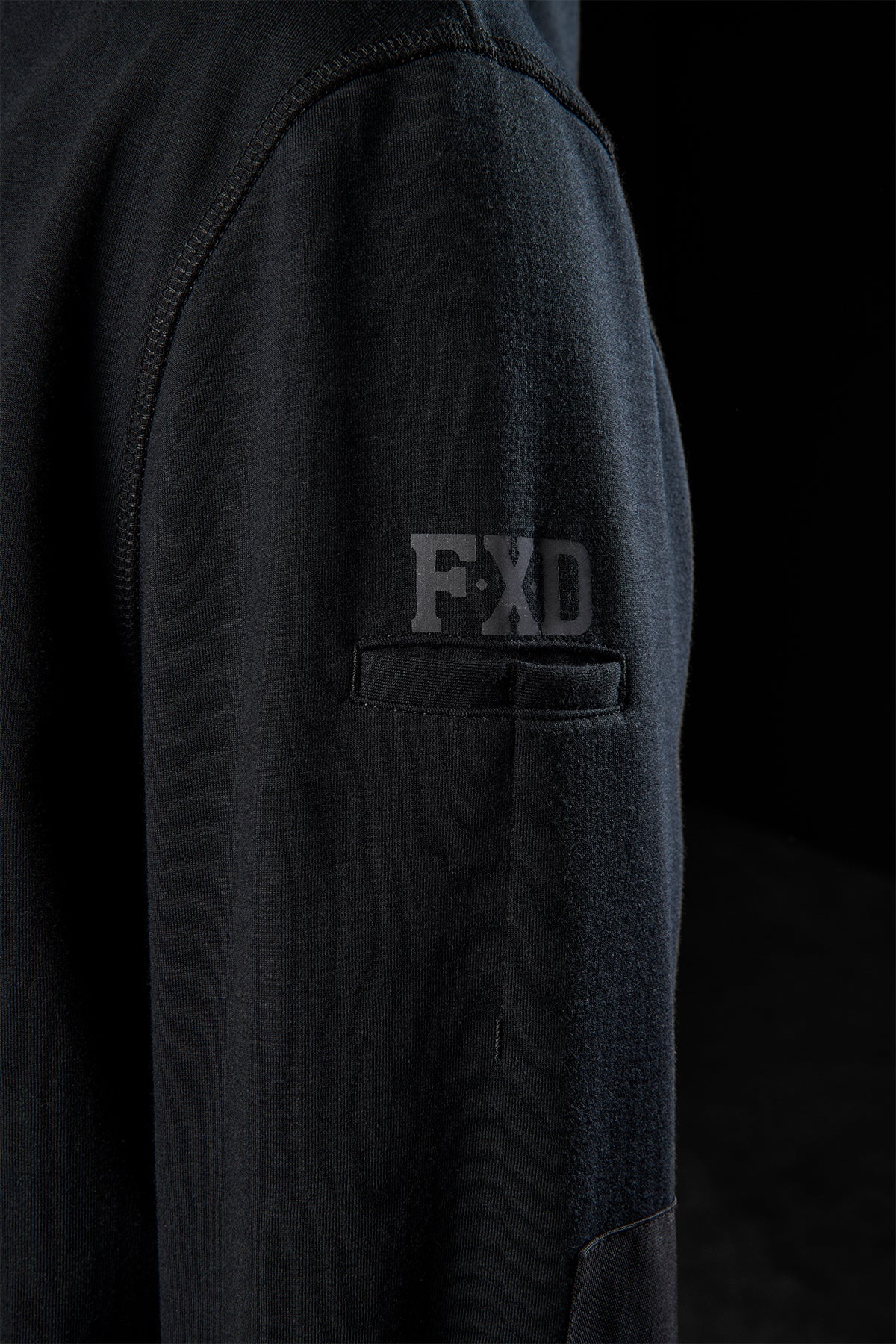 WF-3 bonded fleece hoodie sleeve close-up with FXD logo near a pocket