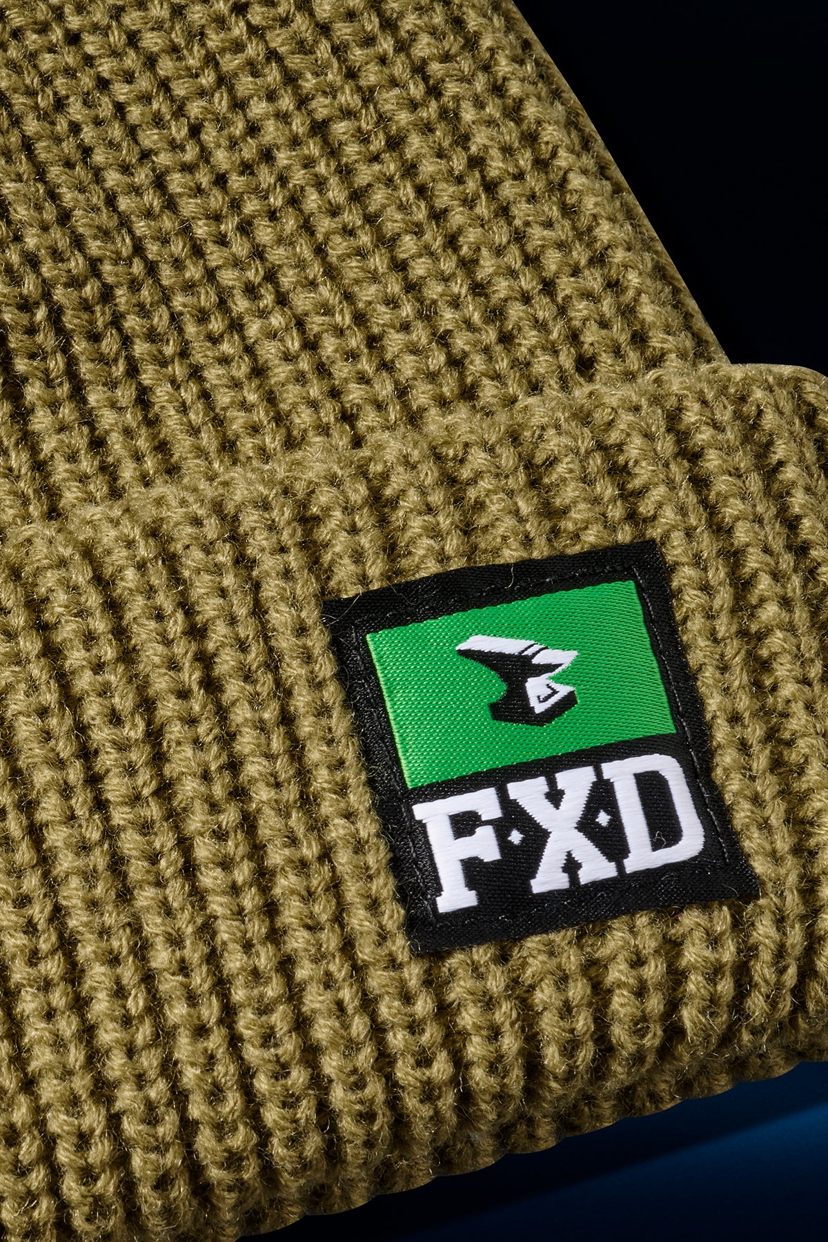 Tan FXD CP-10 classic work beanie knit close up with a green woven label