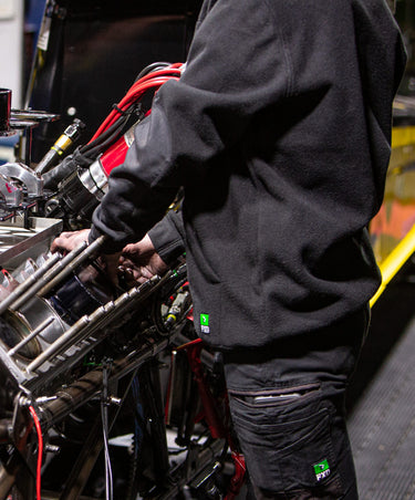 Person working in auto shop wearing WF1 Wrok Fleece 1 hoodie